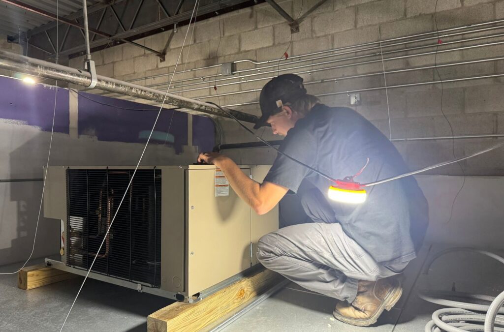 Franklin Heating Cooling and Refrigeration technician servicing a commercial air handler for HVAC contractor services in Grove City, OH. HVAC contractor near me.