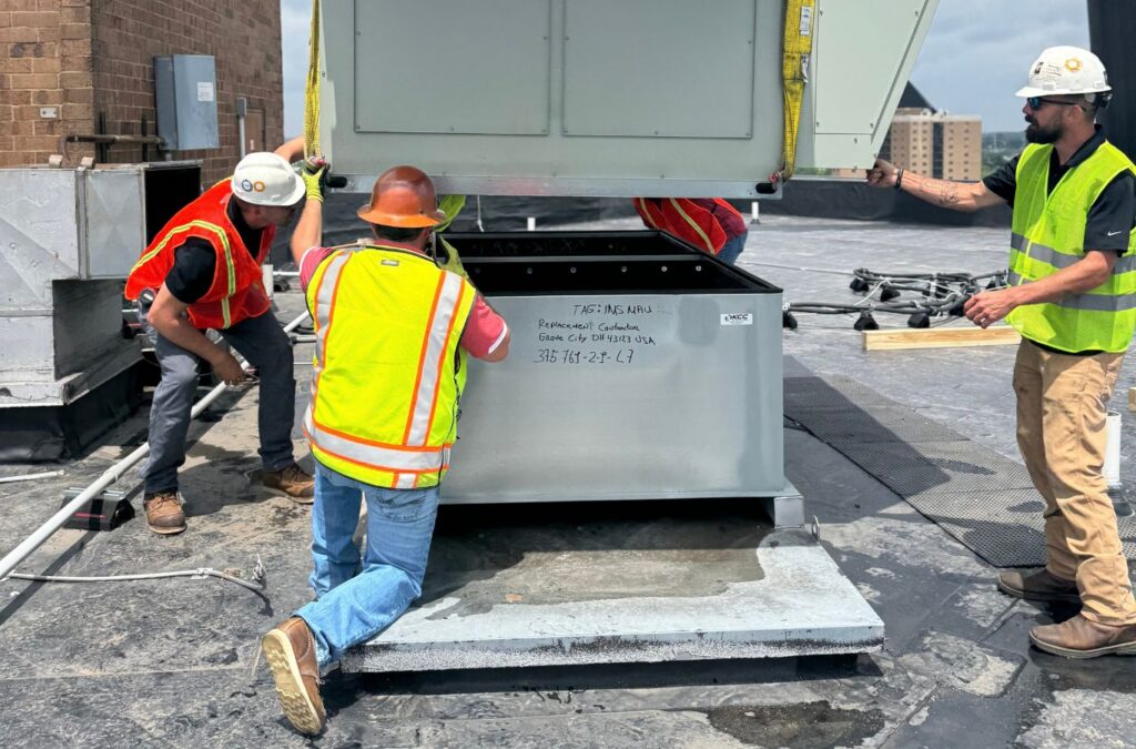 Franklin Heating Cooling and Refrigeration crew positioning commercial HVAC equipment for HVAC contractor services in Reynoldsburg, OH. HVAC contractor near me.