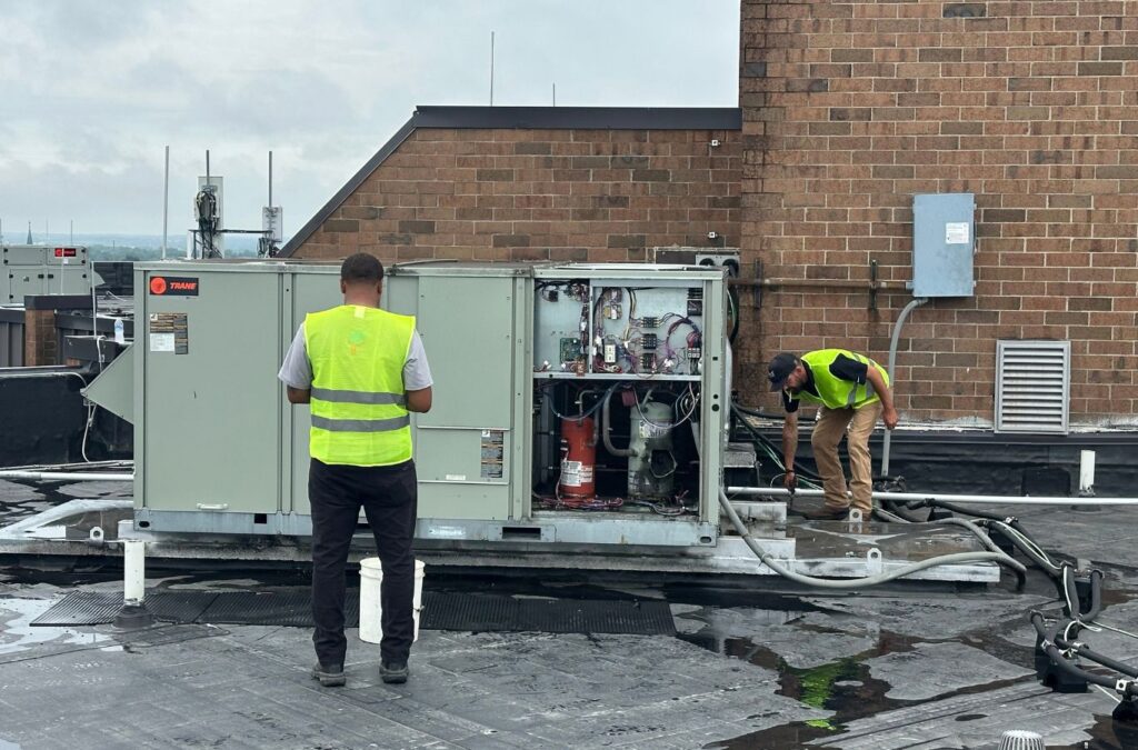 Franklin Heating Cooling and Refrigeration technicians maintaining a rooftop HVAC unit for HVAC contractor services in Delaware, OH. HVAC contractor near me.