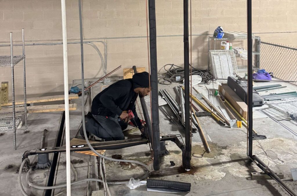 Franklin Heating Cooling and Refrigeration technician installing commercial mechanical equipment for HVAC contractor services in Westerville, OH. HVAC contractor near me.
