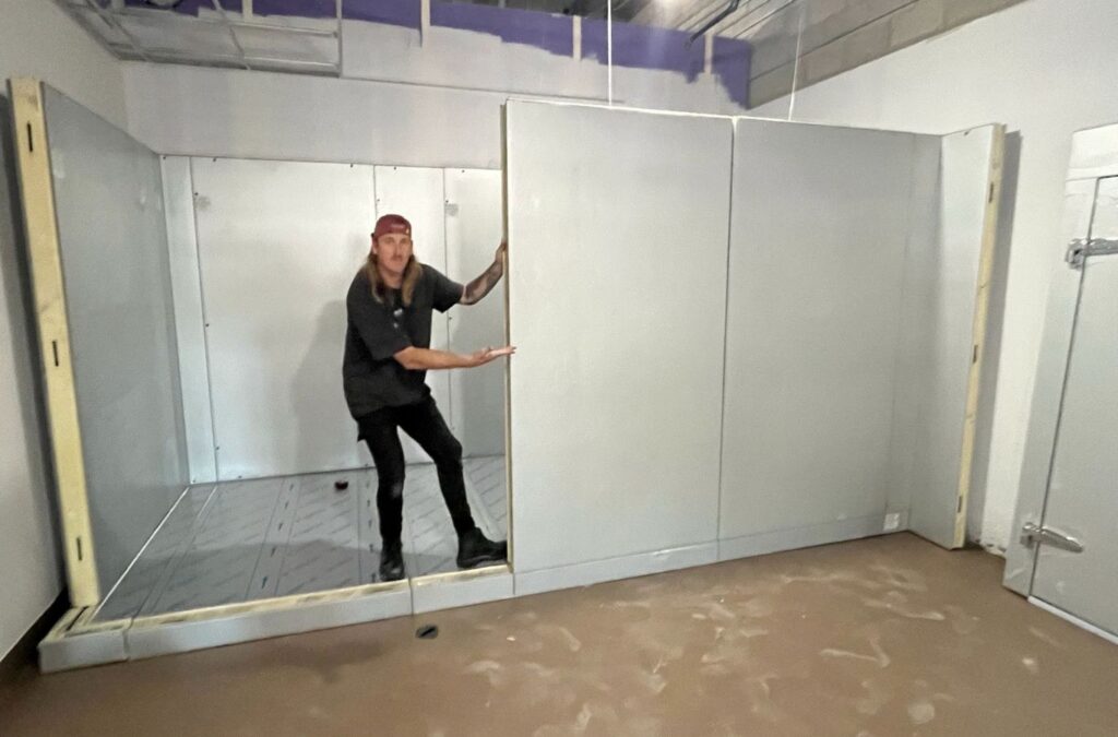 Franklin Heating Cooling and Refrigeration technician working on a walk-in cooler for HVAC contractor services in Canal Winchester, OH. HVAC contractor near me.