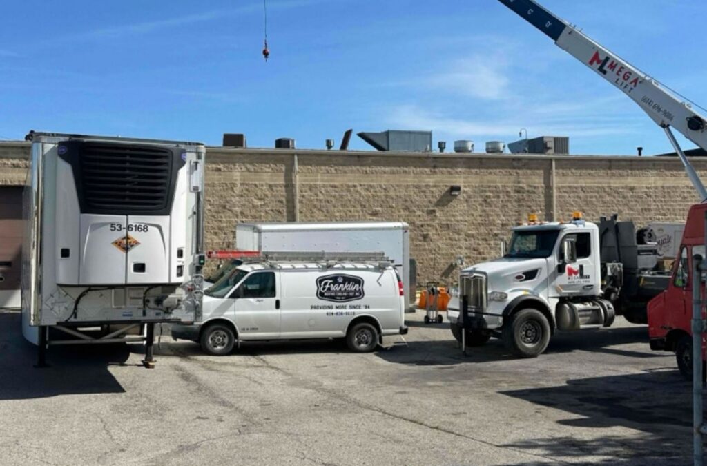 Franklin Heating Cooling and Refrigeration service vehicles and crane at an HVAC project for HVAC contractor services in Westerville, OH. HVAC contractor near me.