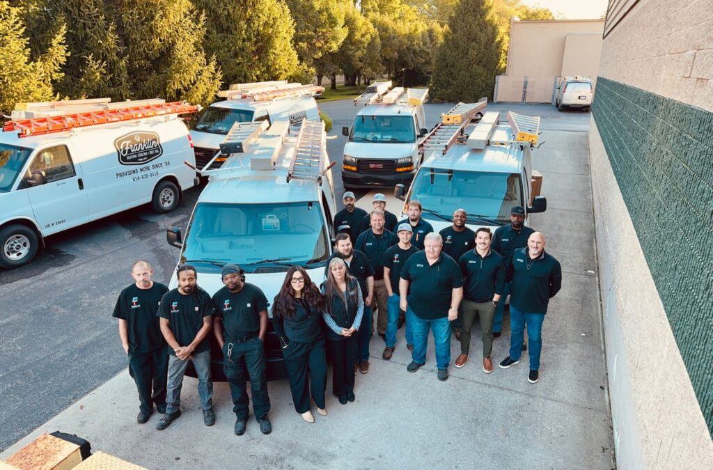 Franklin Heating Cooling and Refrigeration team standing with the service fleet for HVAC contractor services in Hilliard, OH. HVAC contractor near me.