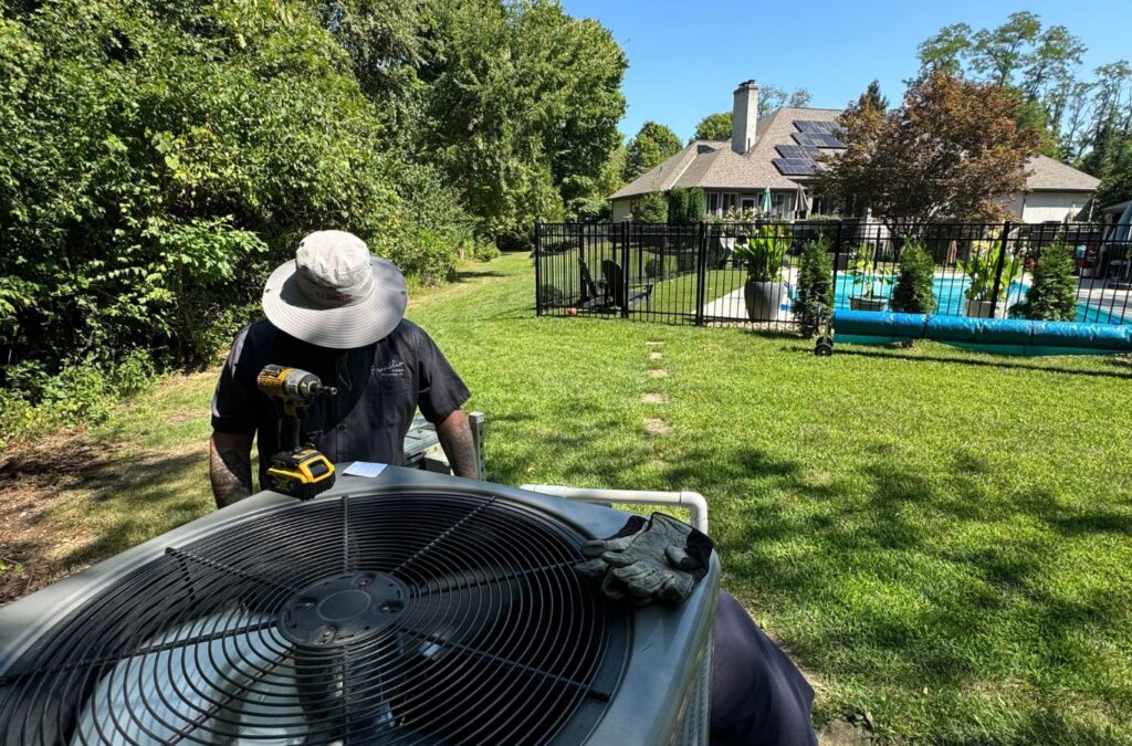 Franklin Heating Cooling and Refrigeration technician servicing an outdoor AC system for HVAC contractor services in Baltimore, OH. HVAC contractor near me.