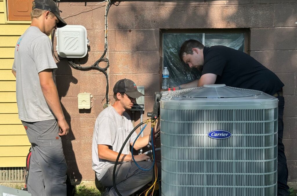 Franklin Heating Cooling and Refrigeration technicians working on a residential AC unit for HVAC contractor services in Gahanna, OH. HVAC contractor near me.
