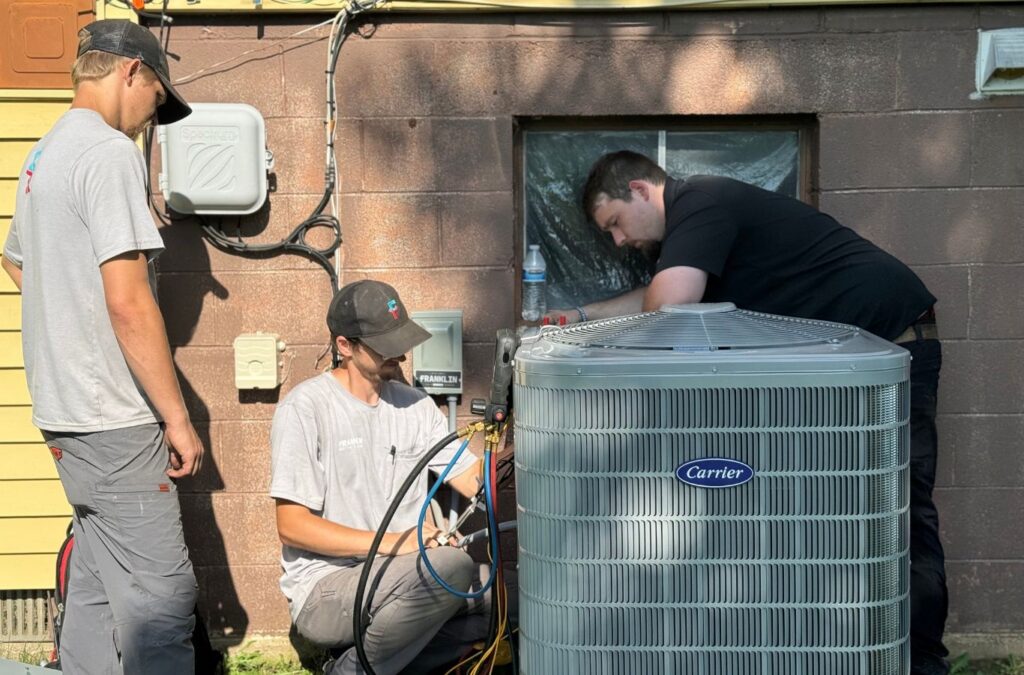 Franklin Heating Cooling and Refrigeration technicians inspecting residential cooling equipment for HVAC contractor services in Dublin, OH. HVAC contractor near me.
